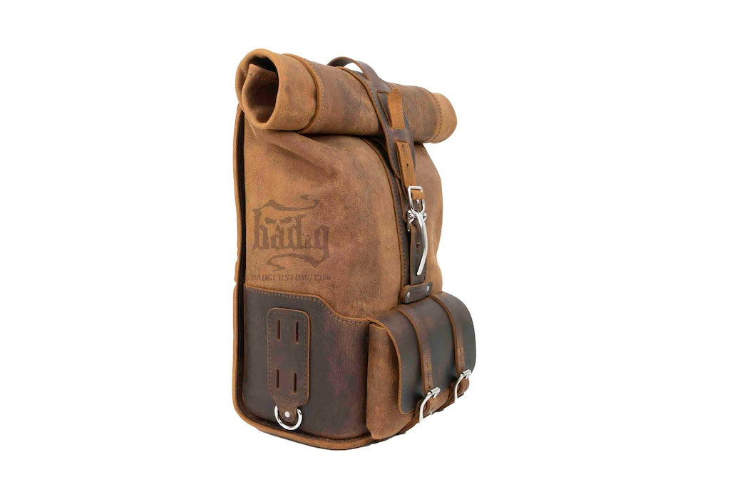 Upgrade your ride with the URB01 Rolltop Backpack Saddlebag. Unique design enables quick conversion from saddlebag to backpack. Hand crafted in USA with premium veg tan water buffalo leather and stainless steel hardware. Durable and stylish, it's the perfect fit for your motorcycle.